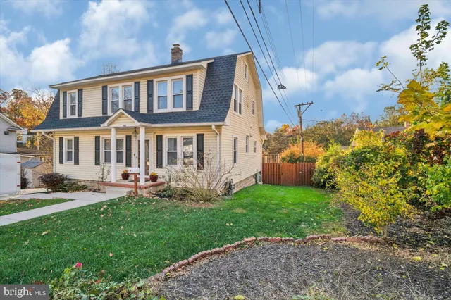 a view of a house with a yard and sitting area