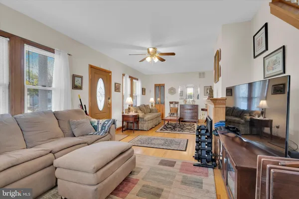 a living room with furniture fireplace and a chandelier