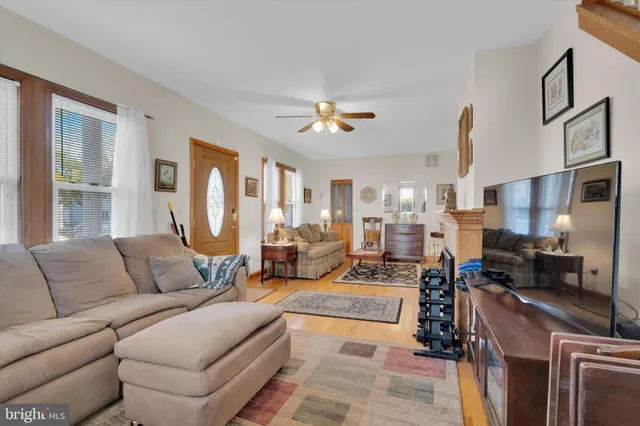 a living room with furniture fireplace and a chandelier