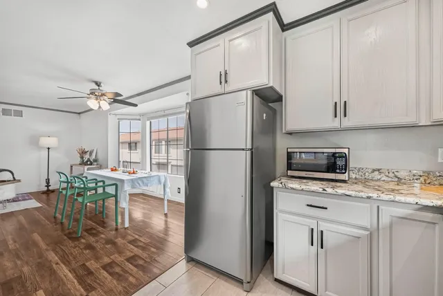 a kitchen with refrigerator cabinets dining table and chairs