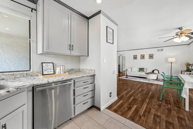 a kitchen with granite countertop a sink and cabinets