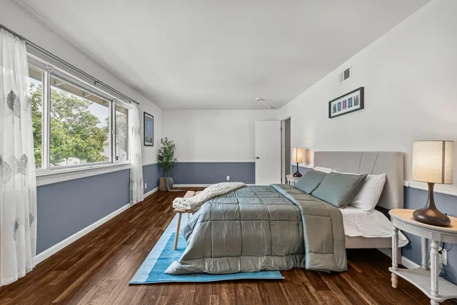 a bed sitting in a bedroom next to a window