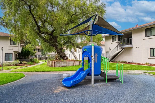 a view of a park with swings and slides