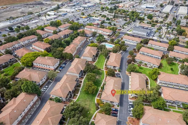 an aerial view of residential houses with outdoor space