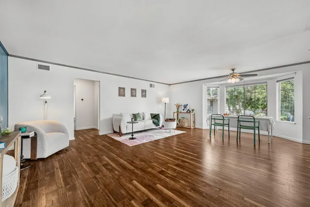 a living room with furniture and wooden floor