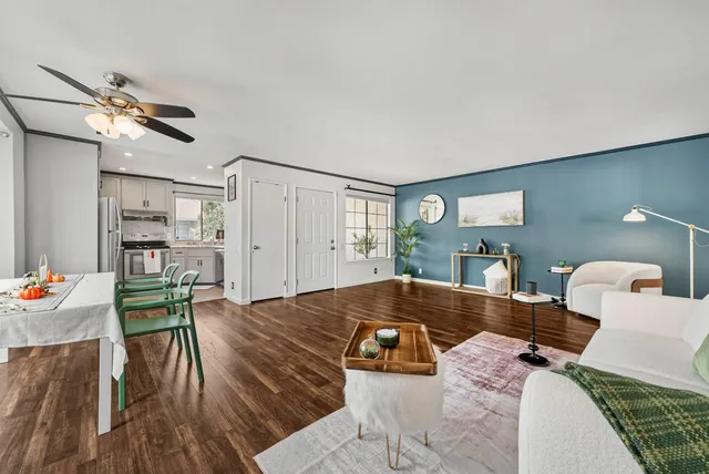 a living room with furniture and wooden floor