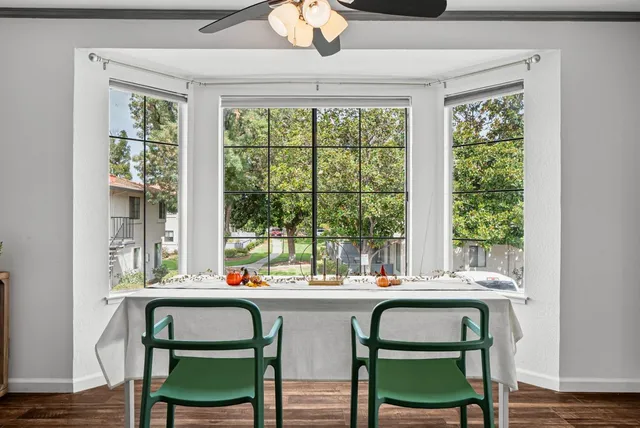a dining room with a window and chairs