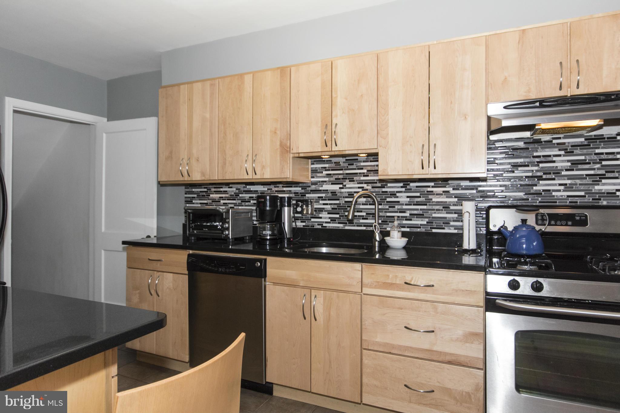 133 Stanmore Road Baltimore, MD 21212 - Photo 3 of 21 a kitchen with granite countertop white cabinets and white appliances