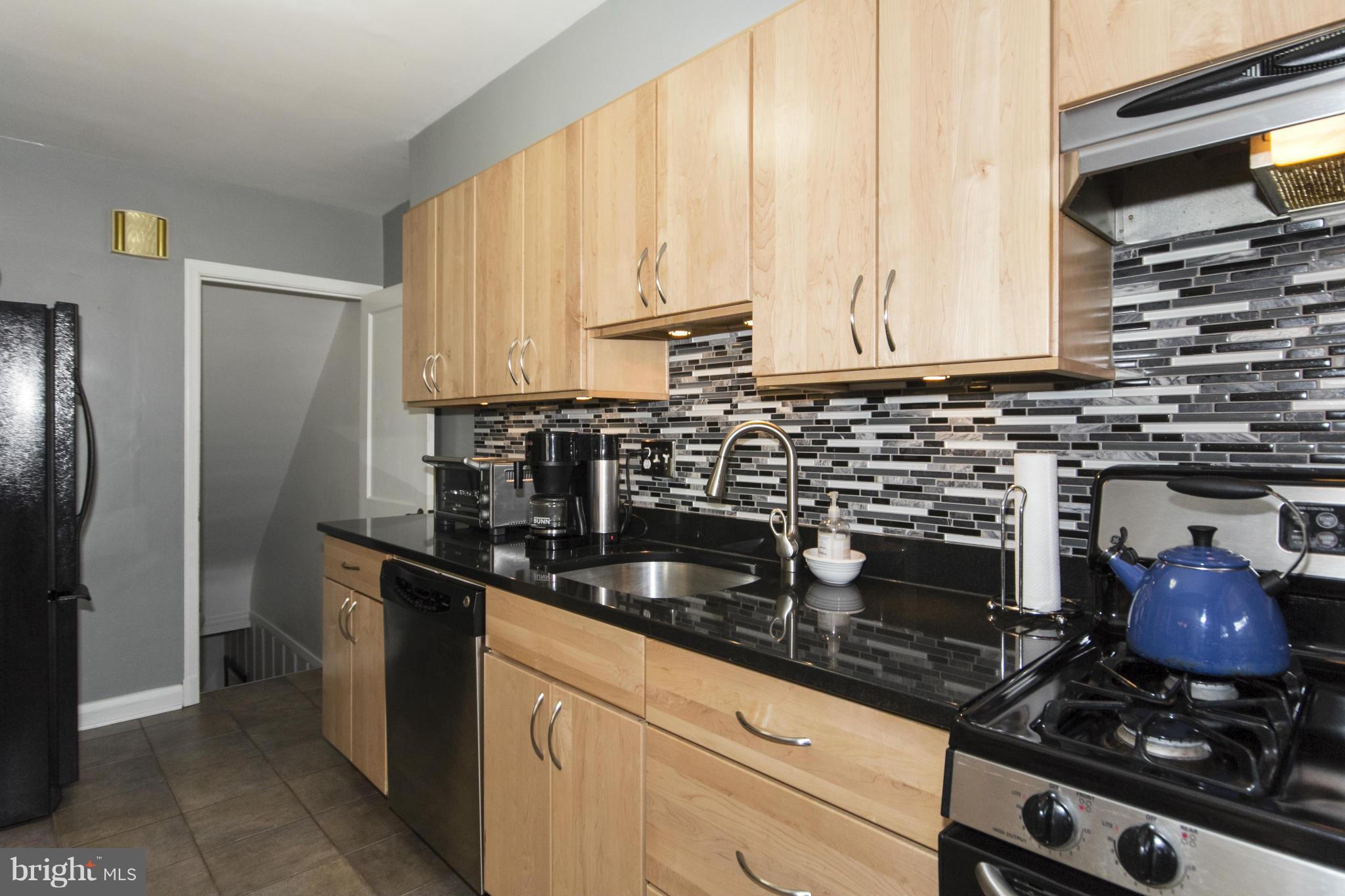 133 Stanmore Road Baltimore, MD 21212 - Photo 4 of 21 a kitchen with stainless steel appliances granite countertop a sink stove and refrigerator