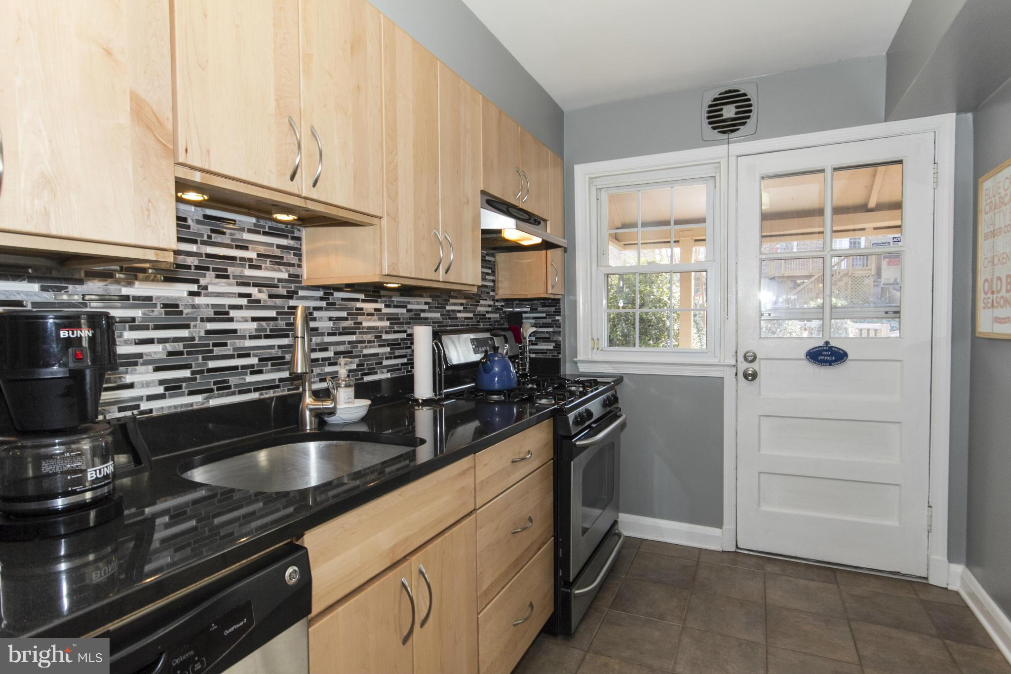 133 Stanmore Road Baltimore, MD 21212 - Photo 5 of 21 a kitchen with granite countertop a sink and a stove top oven