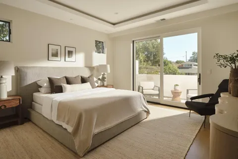 a bedroom with a bed and glass window