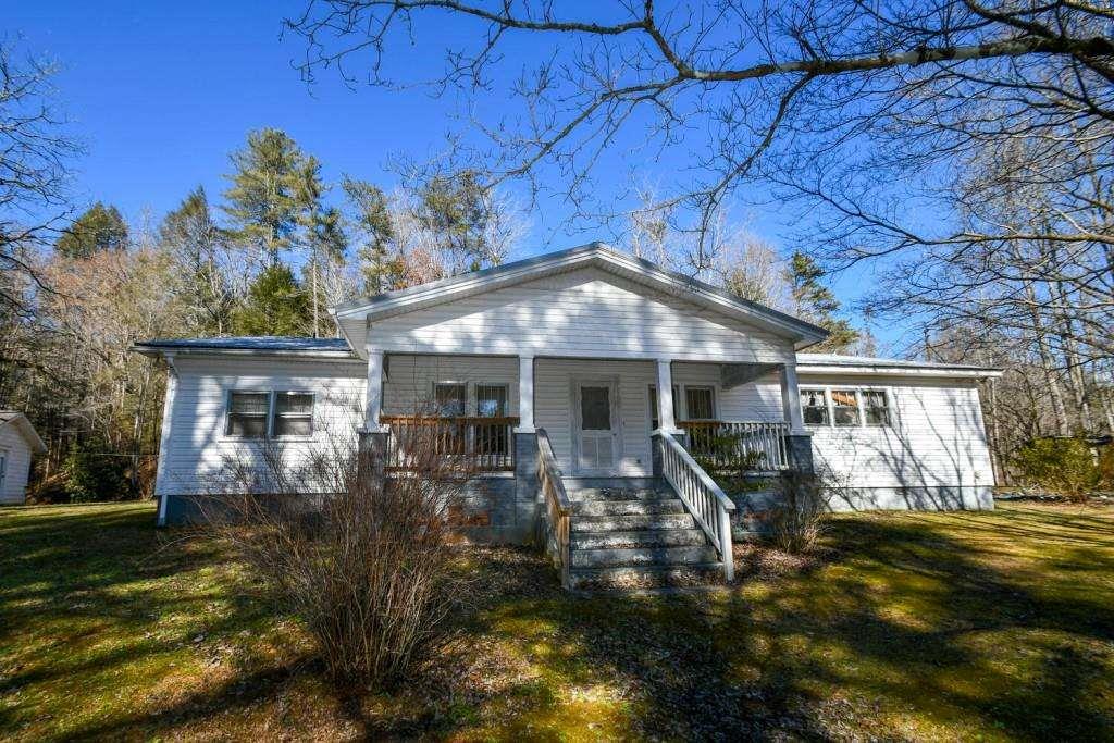 a front view of house with a garden