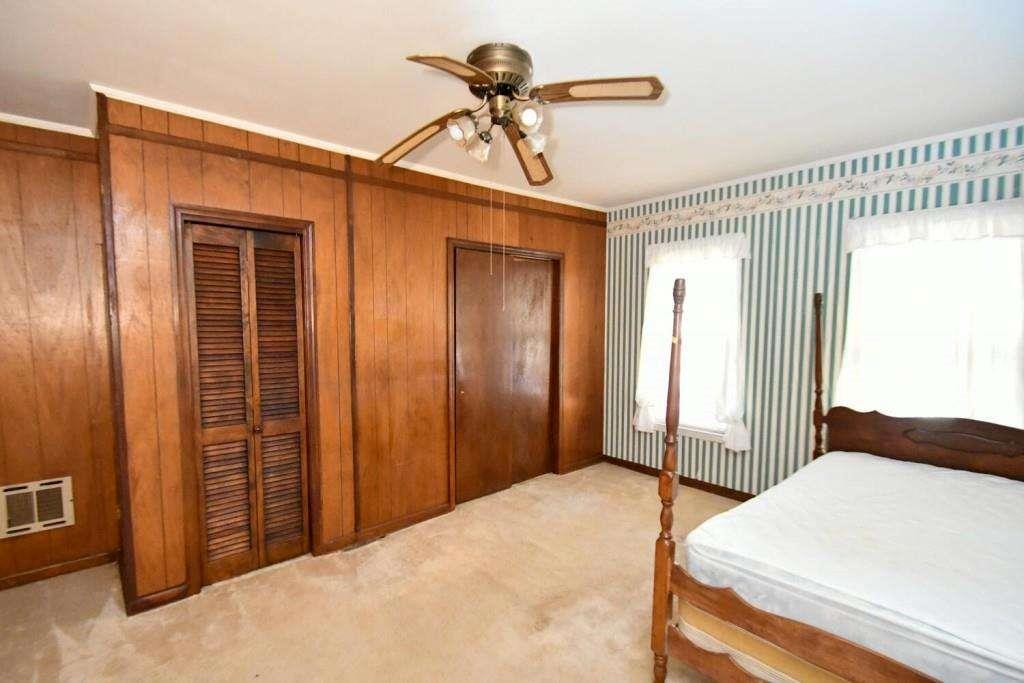 18 Corinth Church Road Cleveland, GA 30528 - Photo 13 of 37 a bedroom with a bed and a chandelier