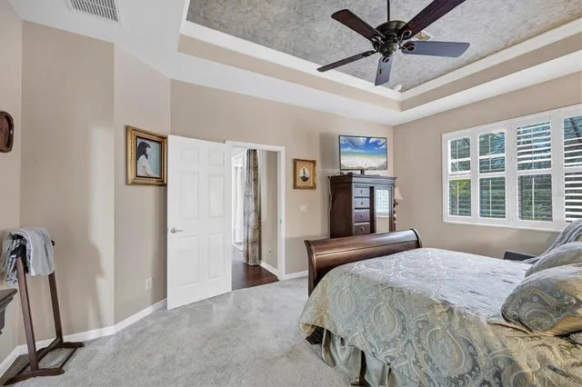 a bedroom with a large bed and a window