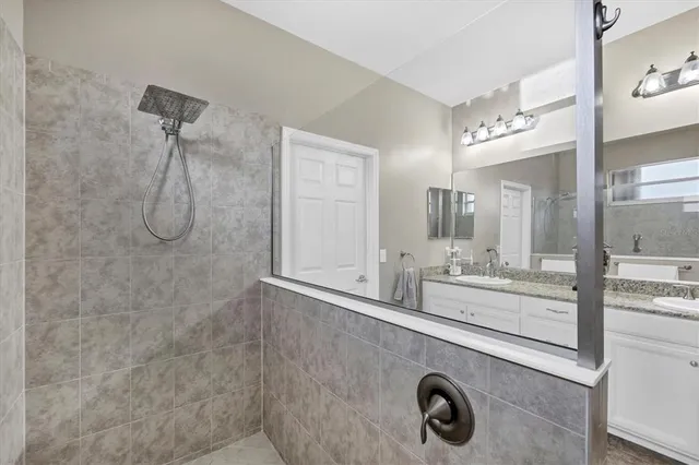 a bathroom with a granite countertop sink a toilet and mirror