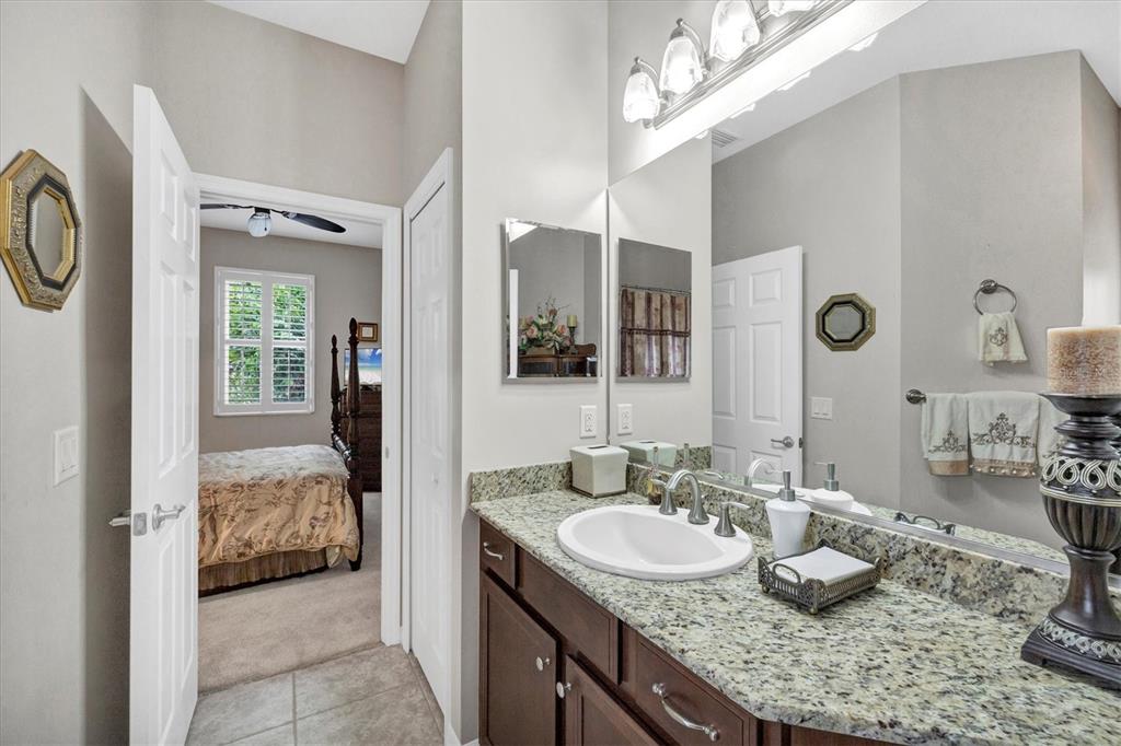 19792 Cobblestone Circle Venice, FL 34292 - Photo 26 of 36 a en suite bathroom with a granite countertop double vanity and a mirror