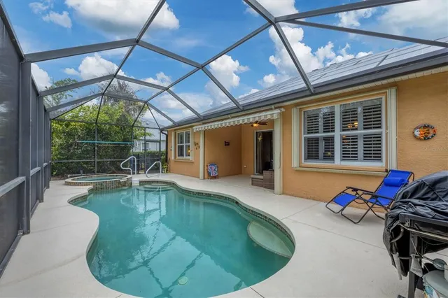 a view of a swimming pool with outdoor seating