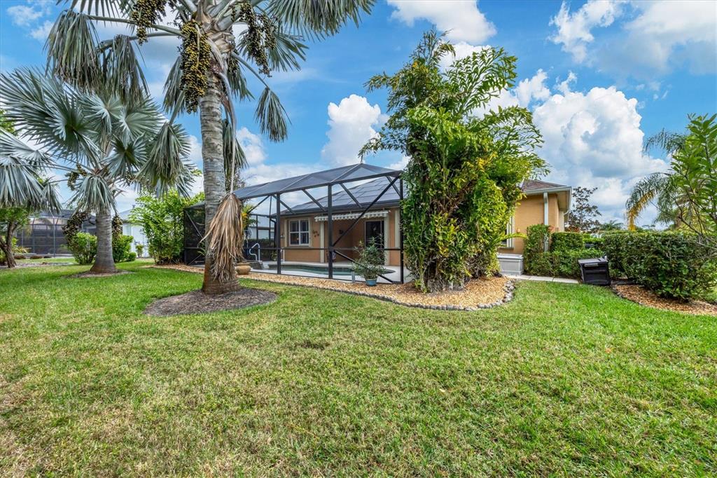19792 Cobblestone Circle Venice, FL 34292 - Photo 34 of 36 a view of a house with a yard and palm trees