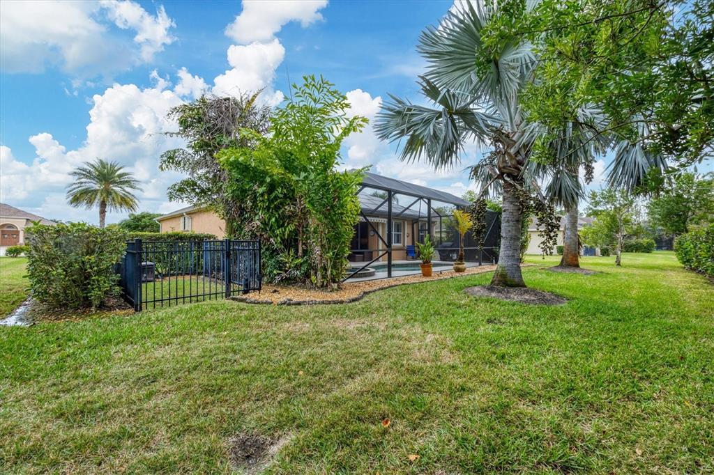 19792 Cobblestone Circle Venice, FL 34292 - Photo 35 of 36 a view of a house with a yard and palm trees