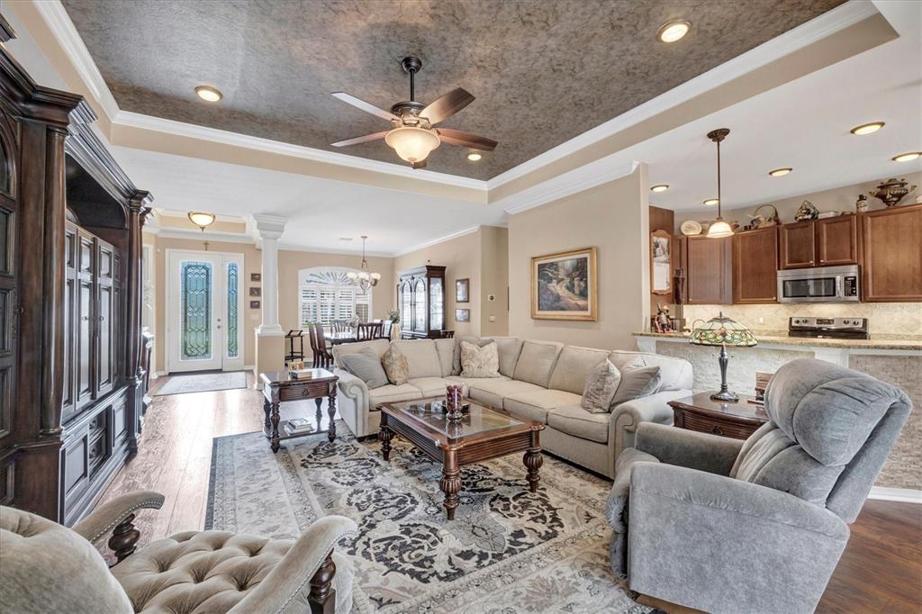 19792 Cobblestone Circle Venice, FL 34292 - Photo 8 of 36 a living room with furniture kitchen and a chandelier