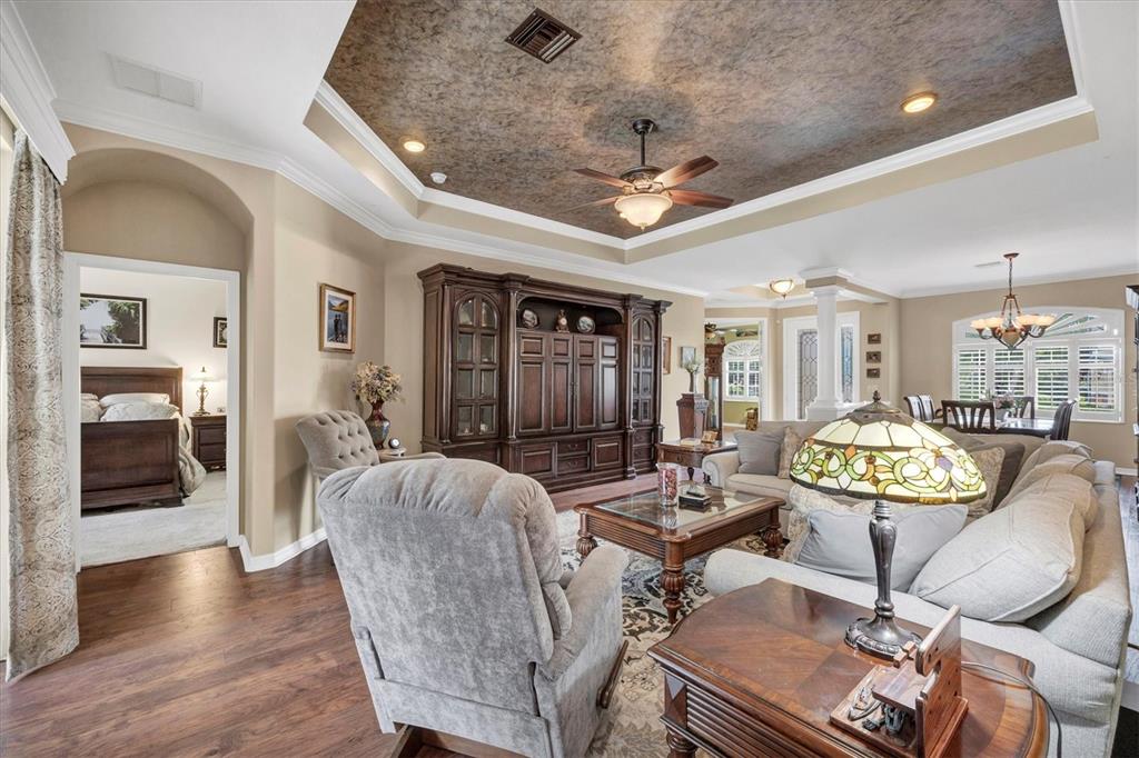 19792 Cobblestone Circle Venice, FL 34292 - Photo 9 of 36 a living room with furniture a chandelier and a wooden floor