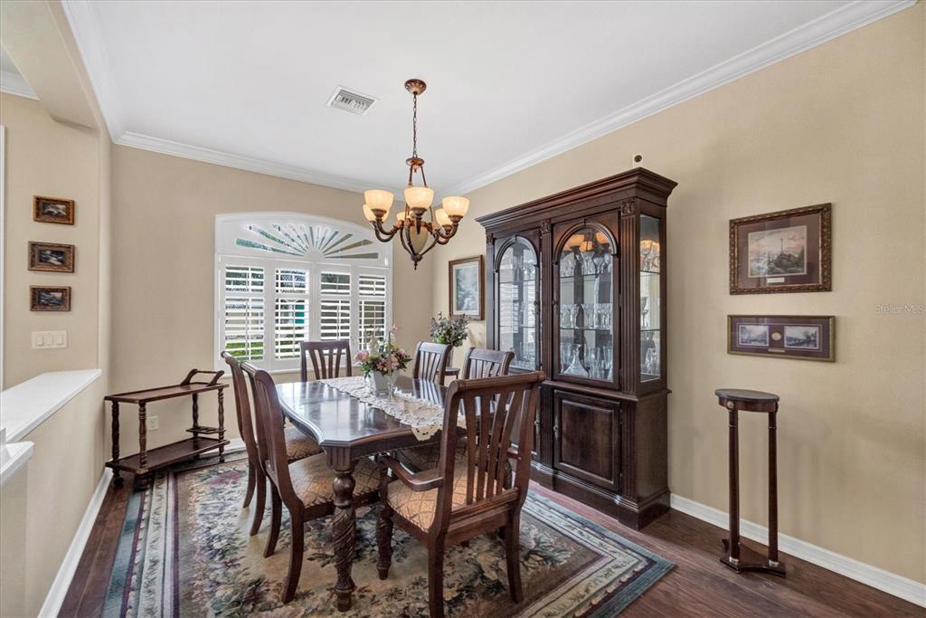 19792 Cobblestone Circle Venice, FL 34292 - Photo 10 of 36 a view of a dining room with furniture window and wooden floor