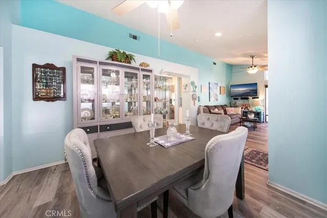 a kitchen with a stove and a wooden floor