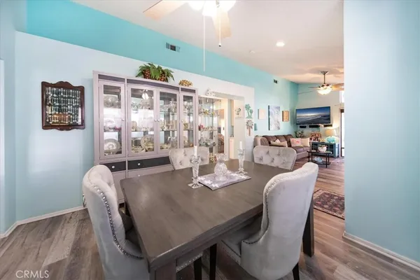 a view of a kitchen with furniture and a refrigerator