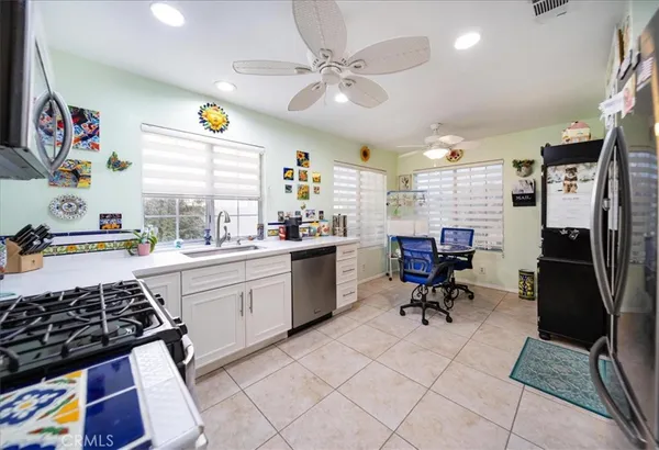 a kitchen with stainless steel appliances cabinets and a window