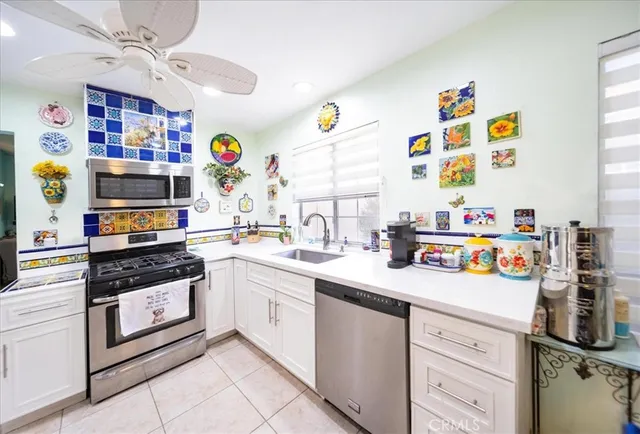 a kitchen with a sink and a stove top oven