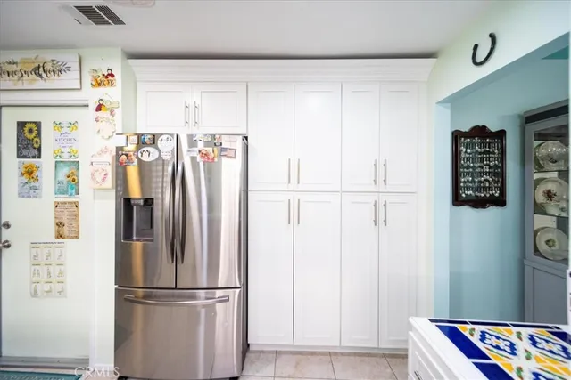 a bedroom with a bed and a large mirror on the dresser