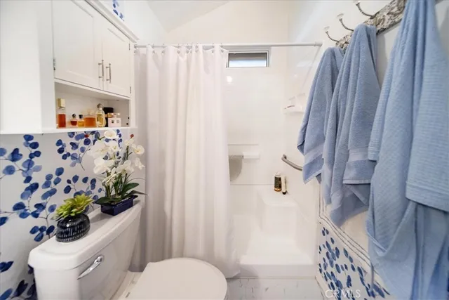 a view of a hallway with paintings on the wall