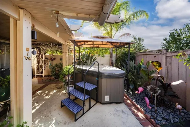 a view of a porch with furniture and garden