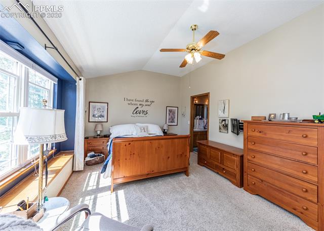 7848 Swiftrun Road Colorado Springs, CO 80920 - Photo 24 of 37 Master bedroom on upper level with ceiling fan and adjoining bath