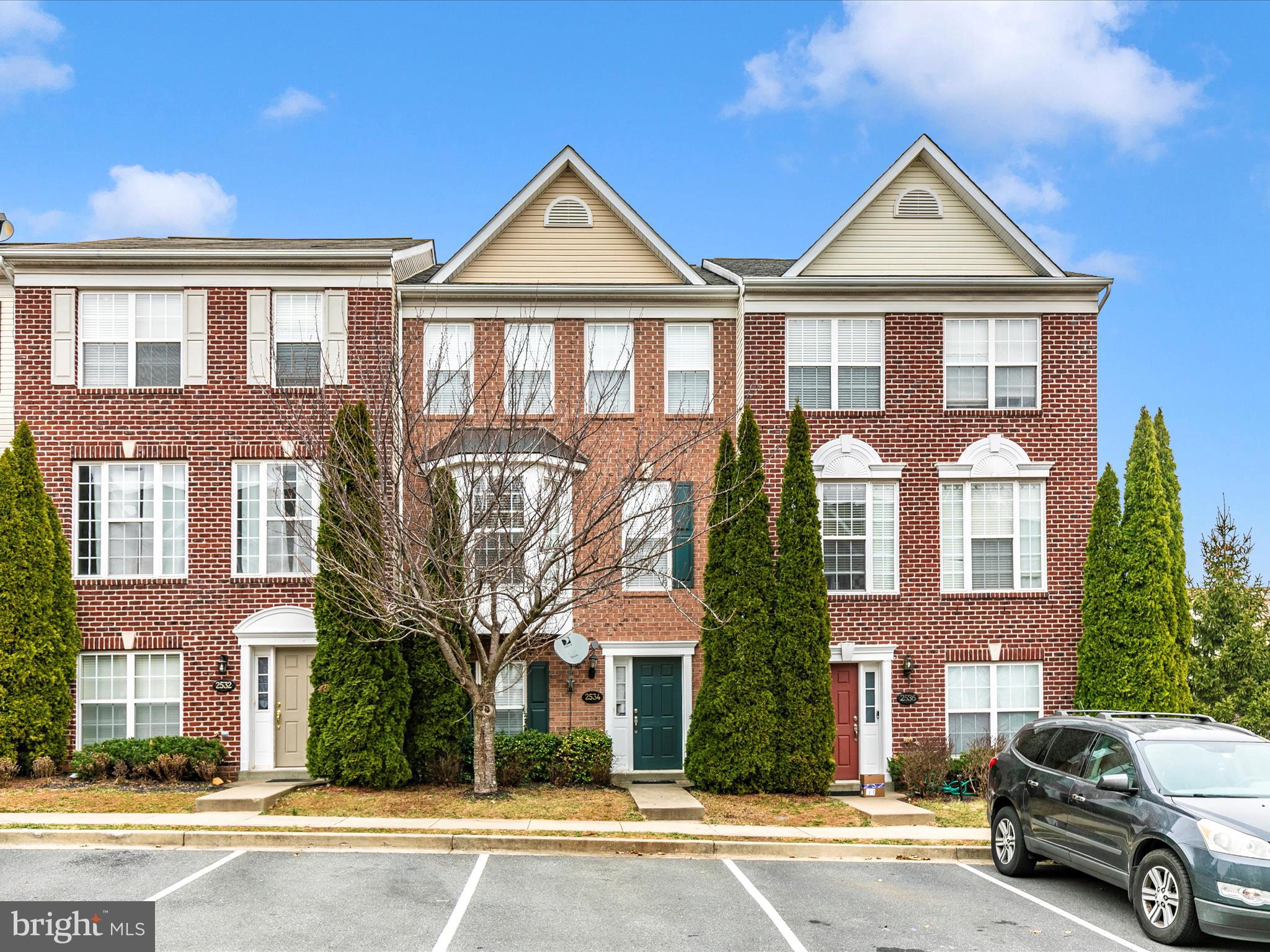 2534 Emerson Drive Frederick, MD 21702 - Photo 1 of 55 a front view of a residential apartment building with a yard