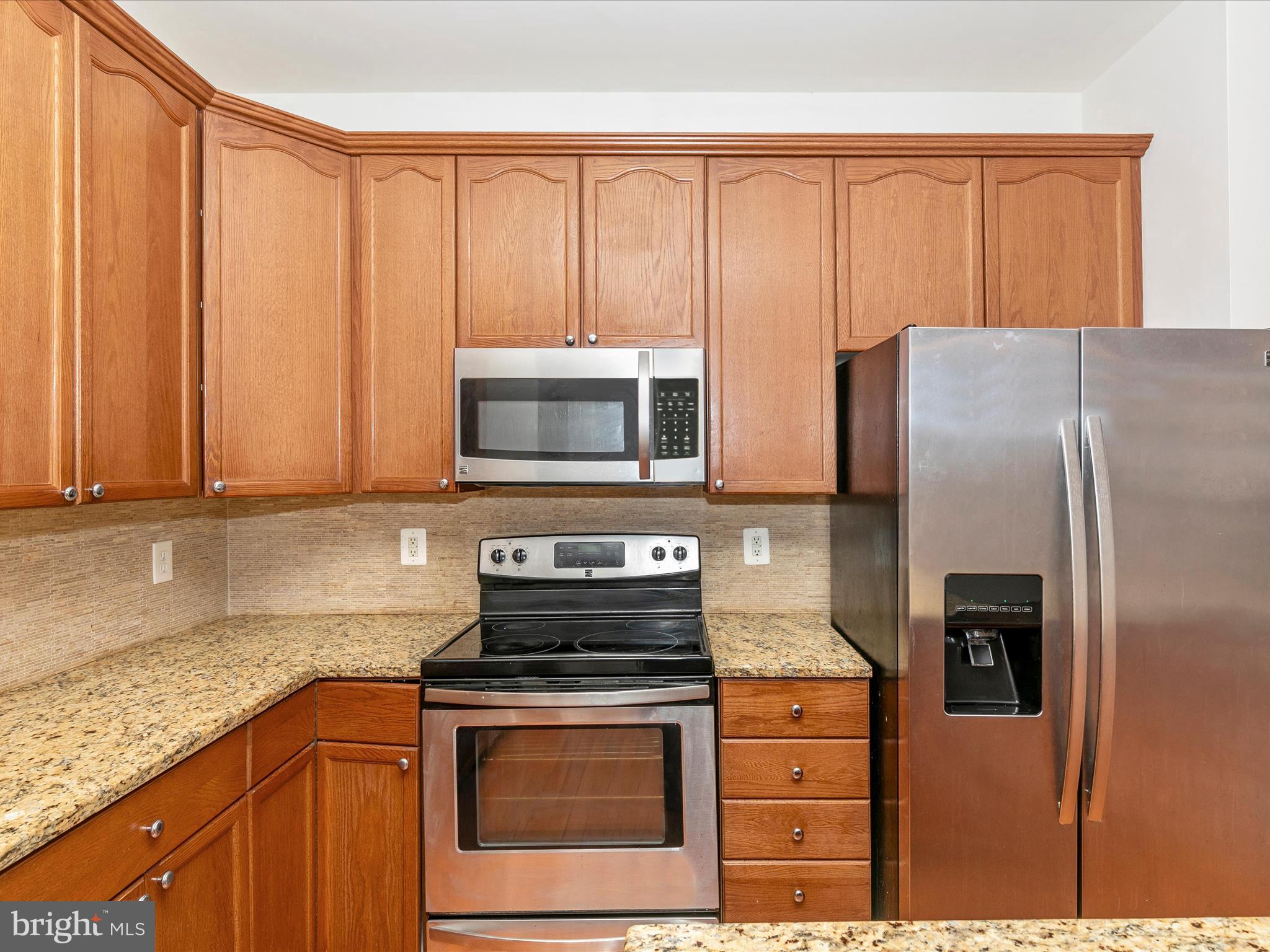 2534 Emerson Drive Frederick, MD 21702 - Photo 25 of 55 a kitchen with stainless steel appliances granite countertop a refrigerator stove and sink
