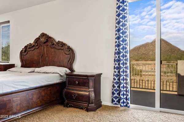 a spacious bedroom with a bed and a chandelier