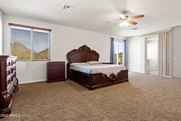 a hallway with a cabinet and a chandelier
