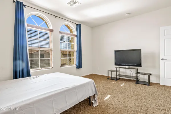 a view of a terrace with a chair and wooden fence