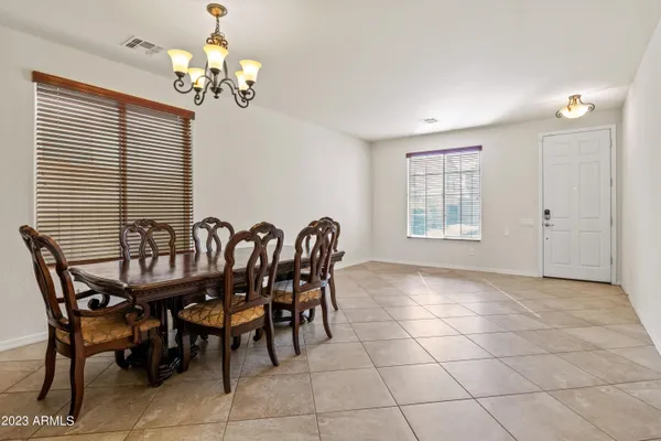 a view of a dining room with furniture and chandelier