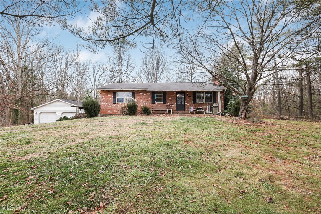 232 McGill Road Vincent, OH 45784 - Photo 2 of 49 Single story home with brick siding, covered porch, a front lawn, and an outdoor structure