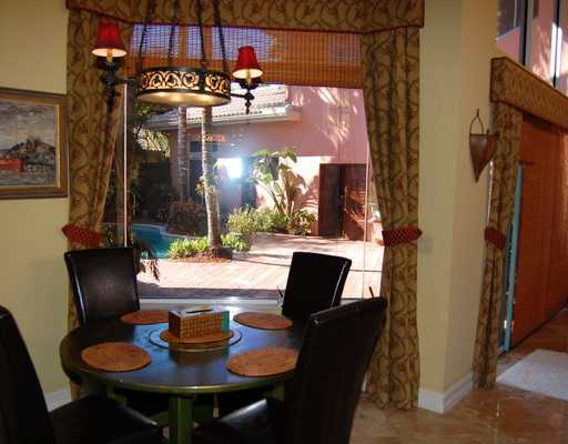 5876 Windsor Terrace Boca Raton, FL 33496 - Photo 15 of 16 a view of a dinning tables and chairs in the patio