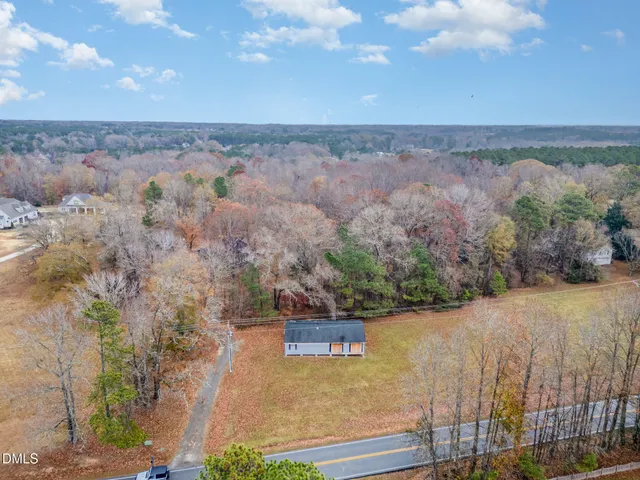 an aerial view of a house with a yard