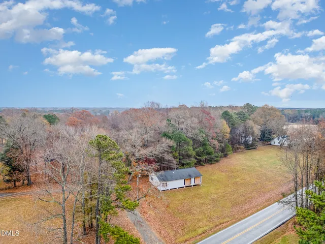 an aerial view of a house with yard