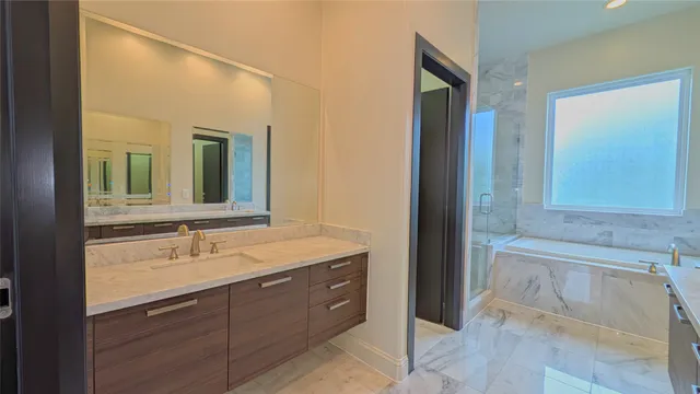 a bathroom with a granite countertop sink and a large mirror