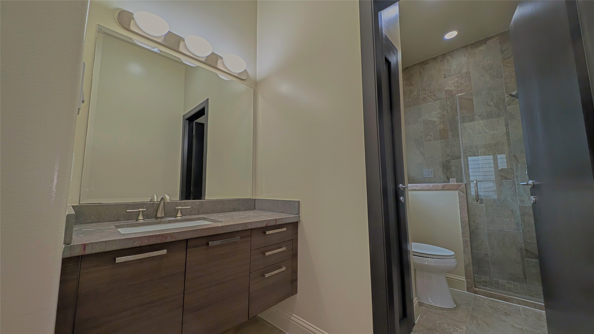 1844 Colquitt Street Houston, TX 77098 - Photo 8 of 40 a bathroom with a granite countertop sink toilet and shower