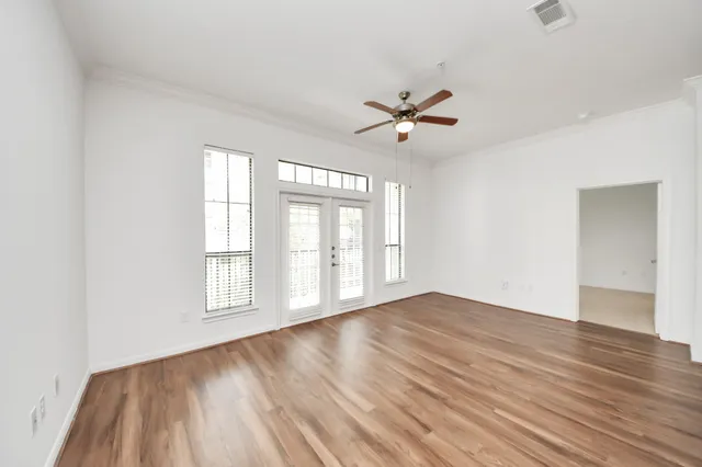 a view of a kitchen with wooden floor and a ceiling fan