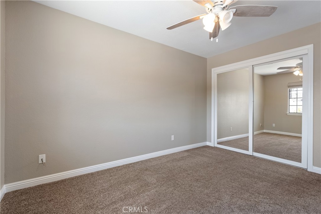 1275 Shane Lane Templeton, CA 93465 - Photo 44 of 70 an empty room with a chandelier fan and windows