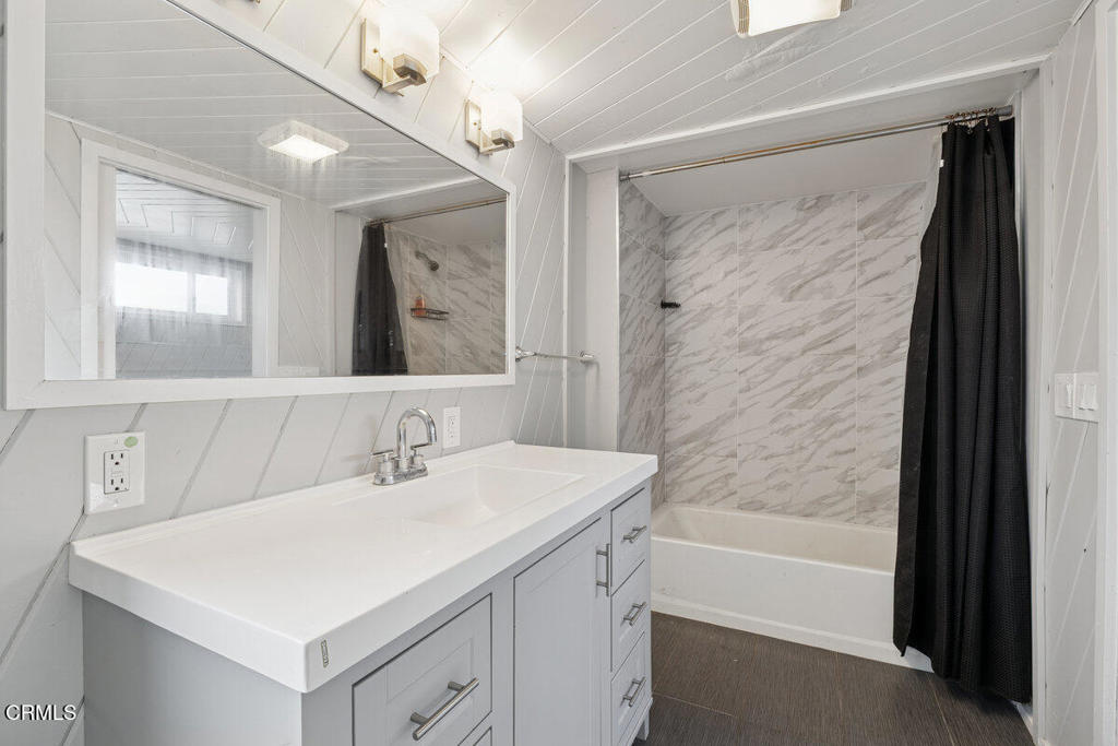 1841 South F Street Oxnard, CA 93033 - Photo 16 of 27 a bathroom with a sink a shower and a mirror