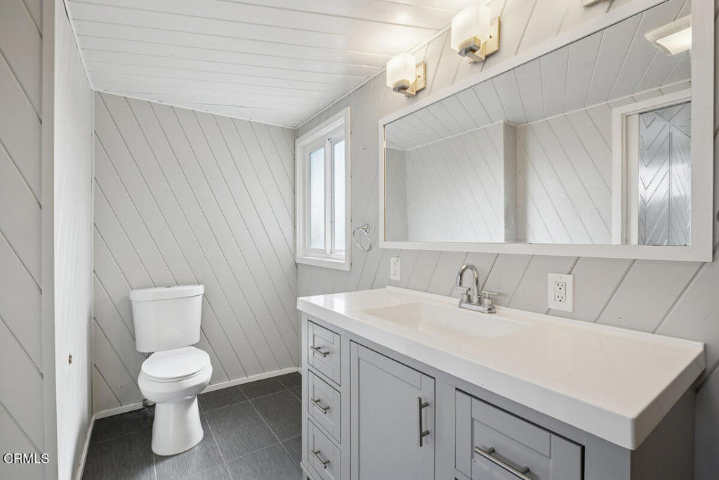 1841 South F Street Oxnard, CA 93033 - Photo 17 of 27 a bathroom with a toilet sink and mirror